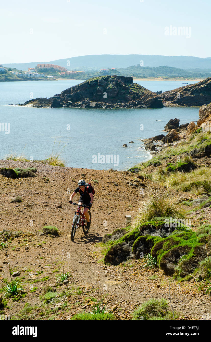 Mountain biker on the Cami de Cavalls coastal path on Menorca in the Balearic islands, Spain Stock Photo