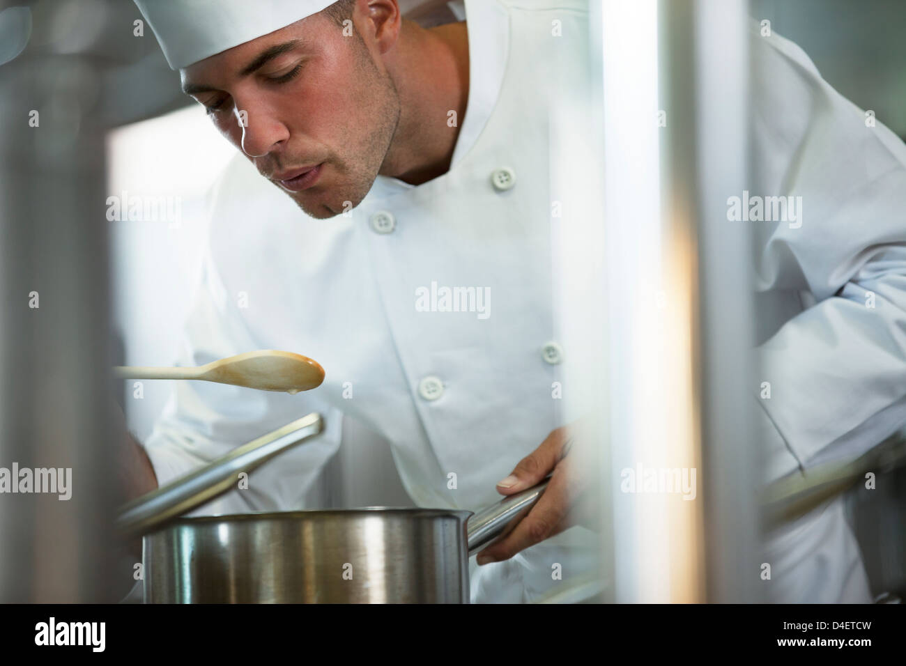 Chef tasting food in restaurant kitchen Stock Photo