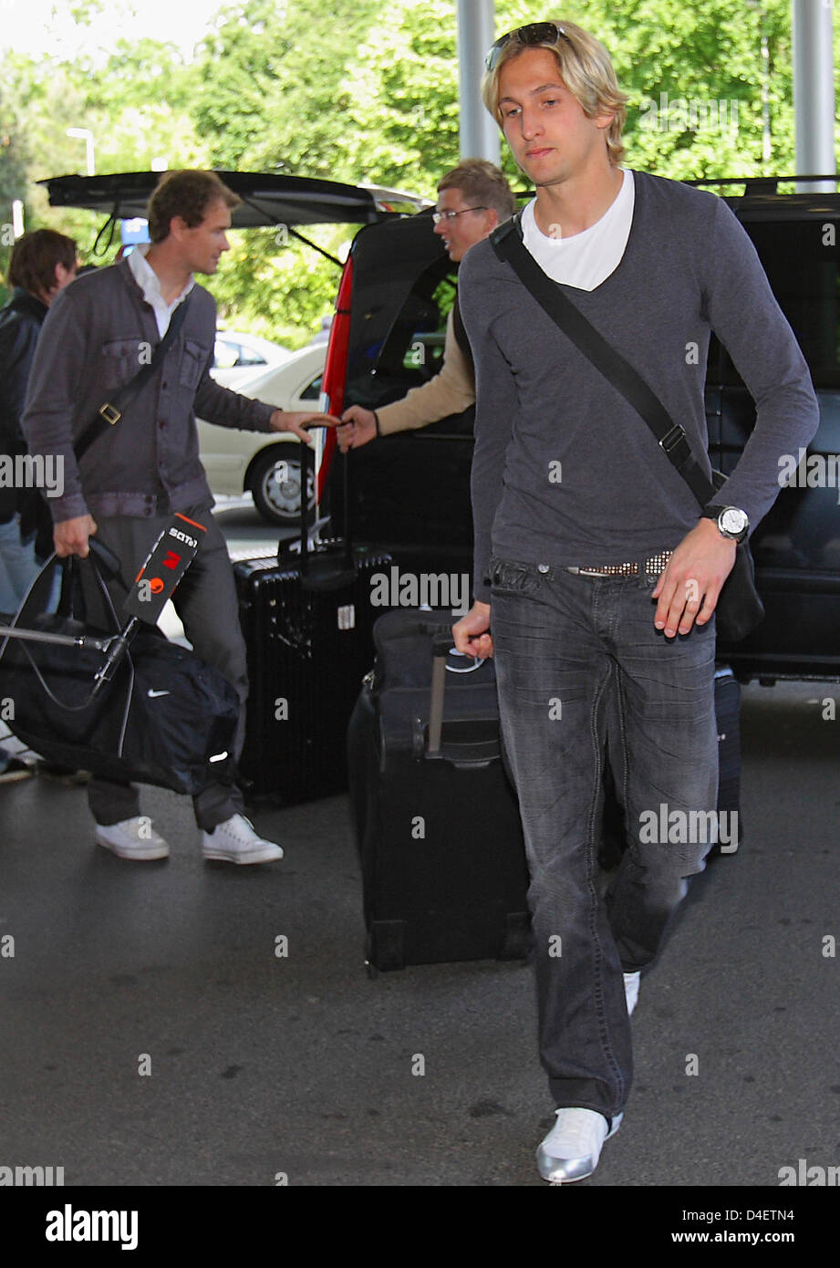 German national substitute goalie Rene Adler exits a car at the airport