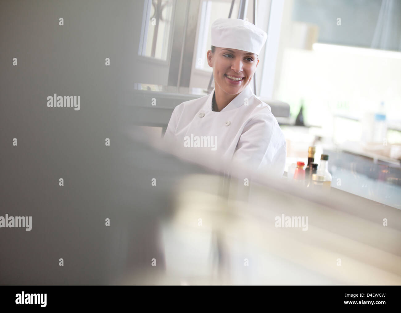 Chef smiling in restaurant kitchen Stock Photo