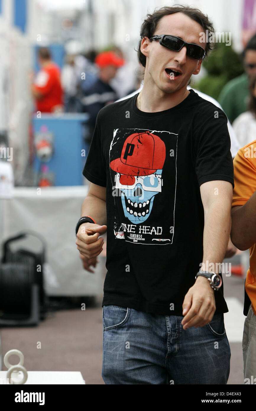 Polish Formula One driver Robert Kubica of BMW Sauber walks through the