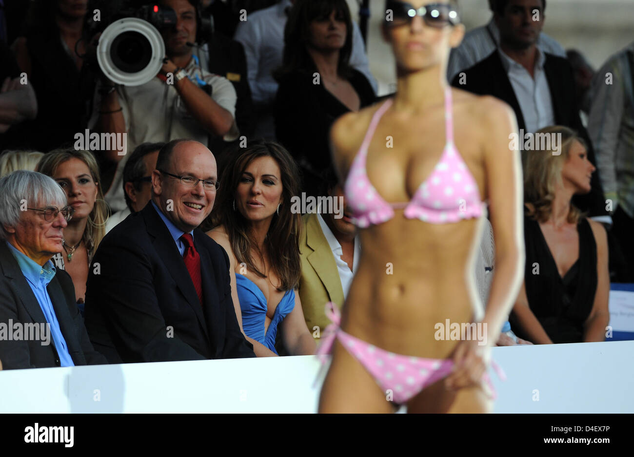 L-R) F1 supremo Bernie Ecclestone, Prince Albert II of Monaco and British  actress and model Liz Hurley watch a model presenting a part of the Liz  Hurley beachwear collection on the catwalk