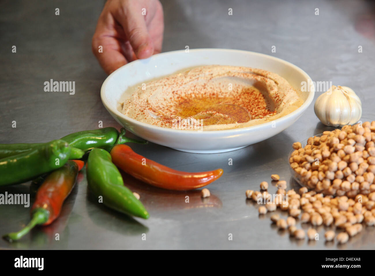 Hummus. A Levantine Arab dip or spread made from cooked, mashed chickpeas, blended with tahini, olive oil, lemon juice, Stock Photo