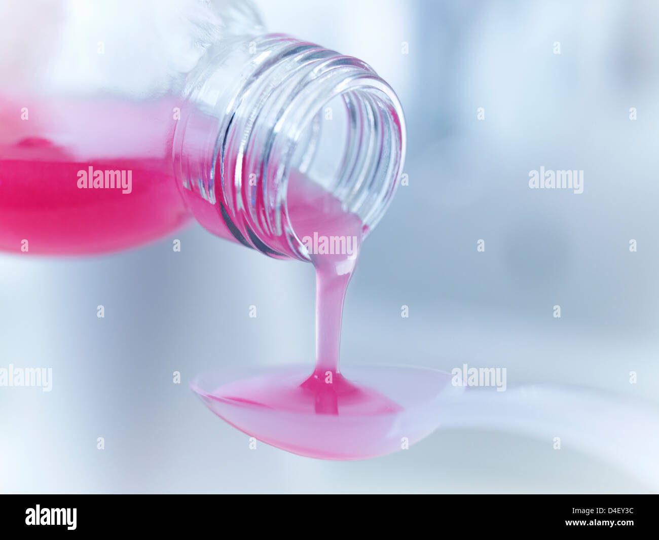 Close up of medicine pouring into measuring spoon Stock Photo