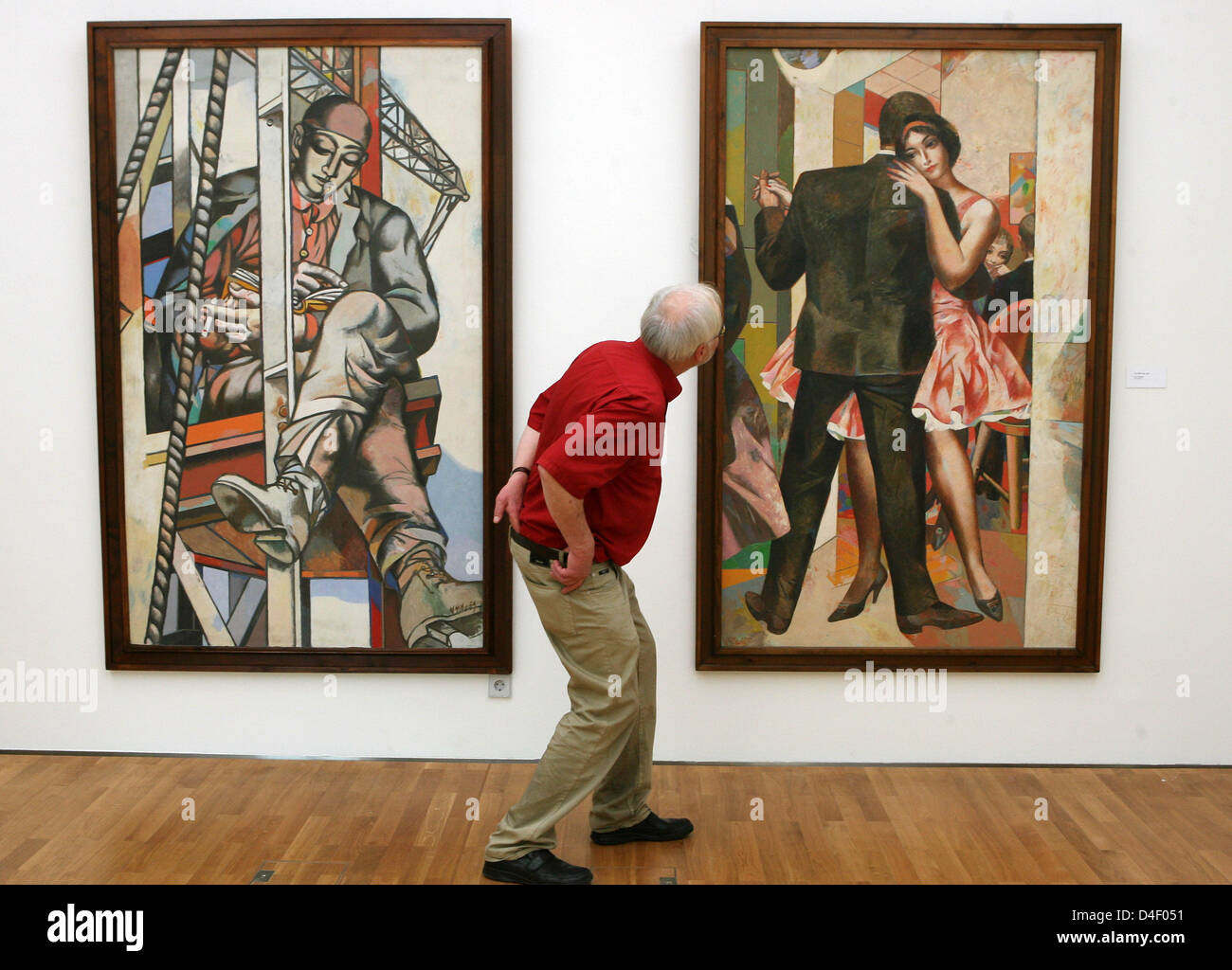A male visitors takes a close look at Willi Sitte's paintings 'Tanzendes Paar' (R, 1961, Dancing Couple) and 'Arbeitspause' (1959, Break from Work) at the Willi-Sitte-Gallery in Merseburg, Germany, 29 May 2008. The gallery shows paintings on the subject of 'The working man' by Sitte, Otto Dix (1891-1969) and Bottrop-based artist Bernhardine Luetzenburg. Two exhibitions will show th Stock Photo