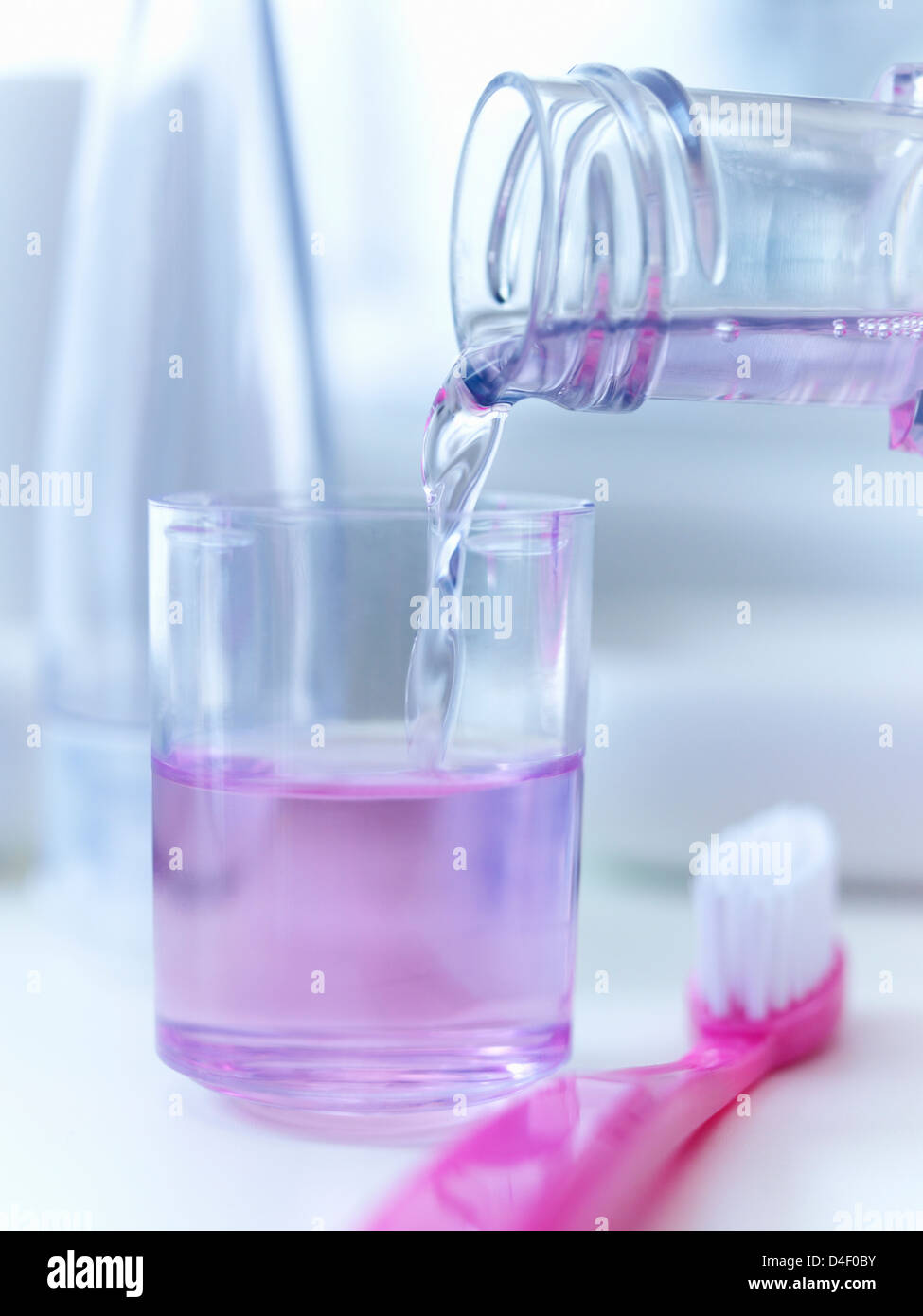 Close up of mouthwash pouring into cup Stock Photo