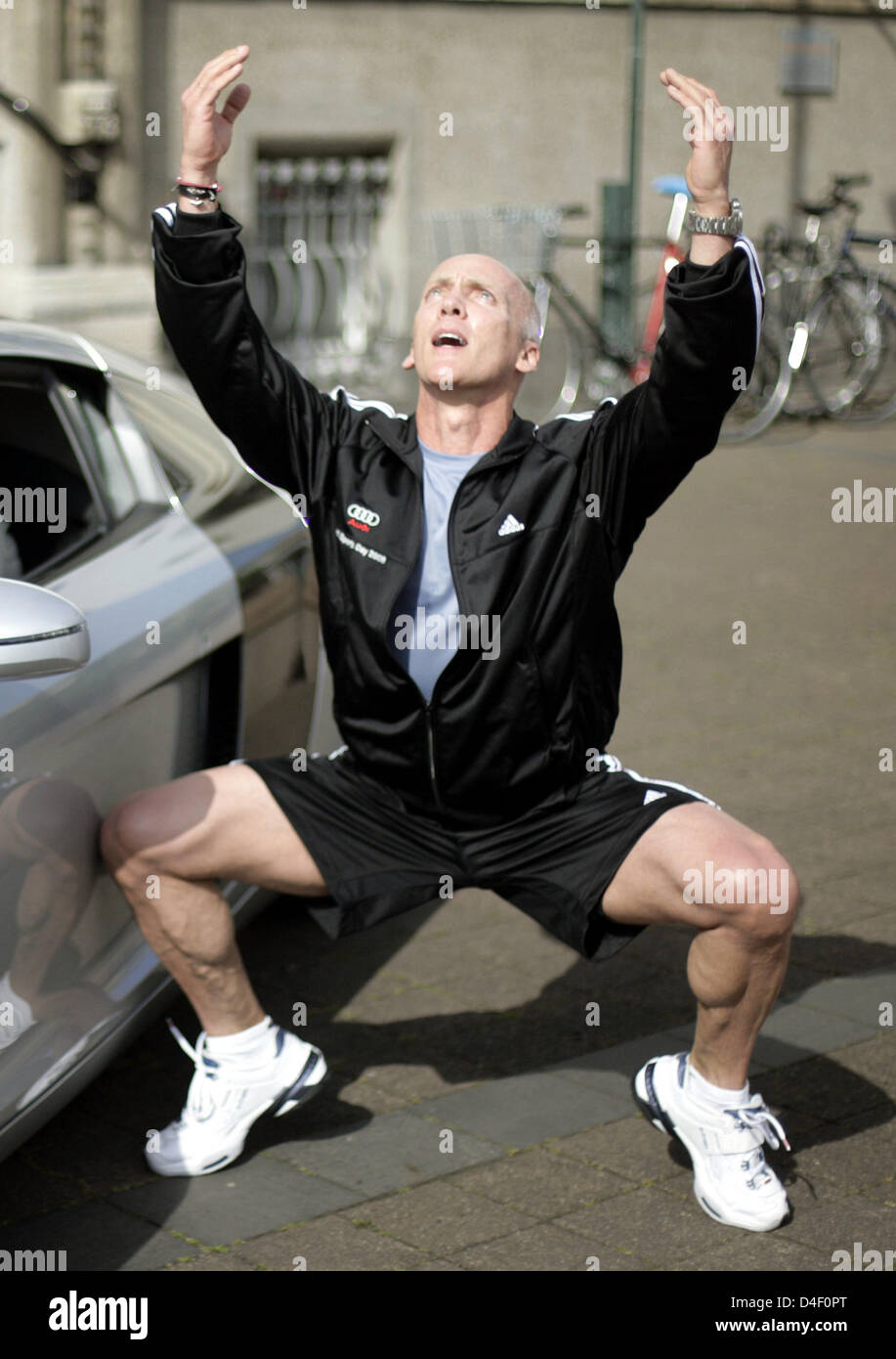 Fitness instructor David Kirsch is pictured during a workout next to a car in Cologne, Germany, 02 June 2008. The car manufacturer 'Audi' invited 50 women to spent a day with Kirsch. Kirsch will give advice on how to stay in good shape and keep a healthy diet. The former lawyer is a successful personal trainer for models and Hollywood actors in the USA. Photo: Joerg Carstensen Stock Photo