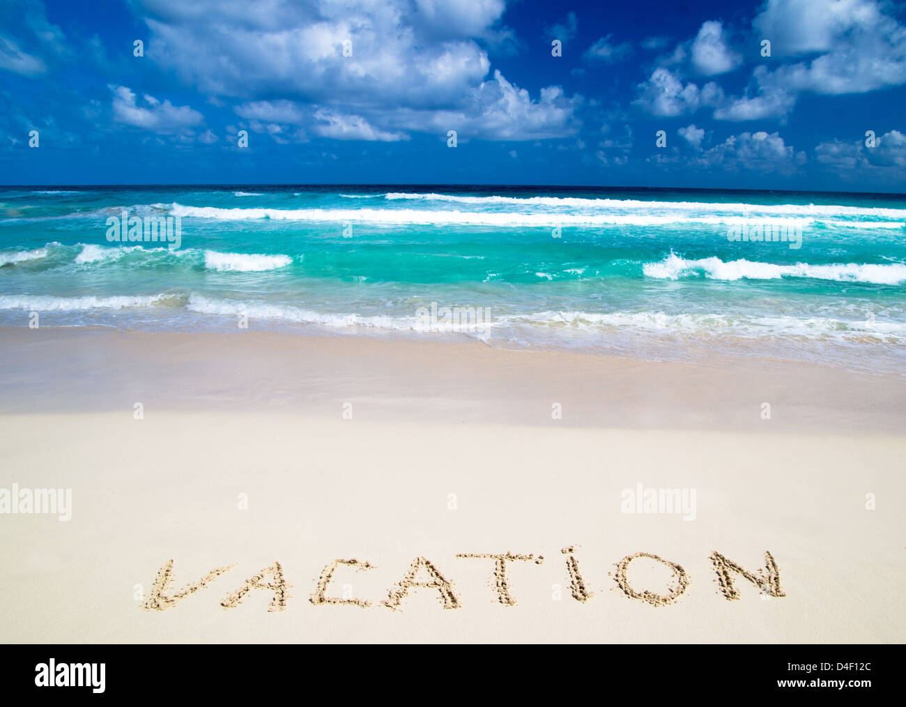 vacation written in a sandy tropical beach Stock Photo - Alamy