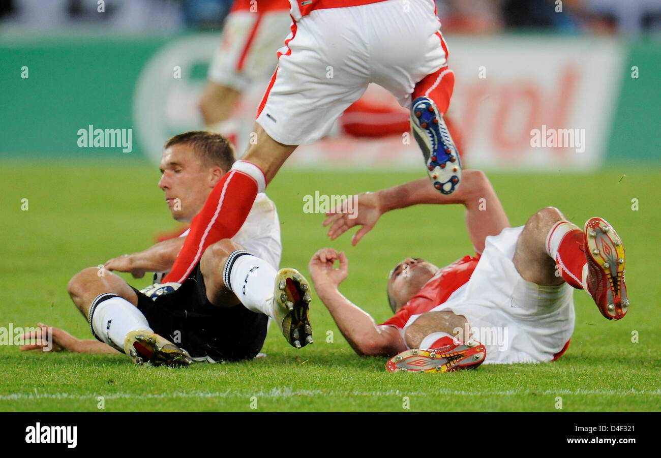 Lukas Podolski (L) of Germany receives a kick between his legs by Dariusz Dudka during the EURO 2008 preliminary round group B match in Woerthersee Stadium, Klagenfurt, Austria, 08 June 2008. Photo: Peter Kneffel dpa +please note UEFA restrictions particularly in regard to slide shows and 'No Mobile Services'+ +++(c) dpa - Bildfunk+++ Stock Photo