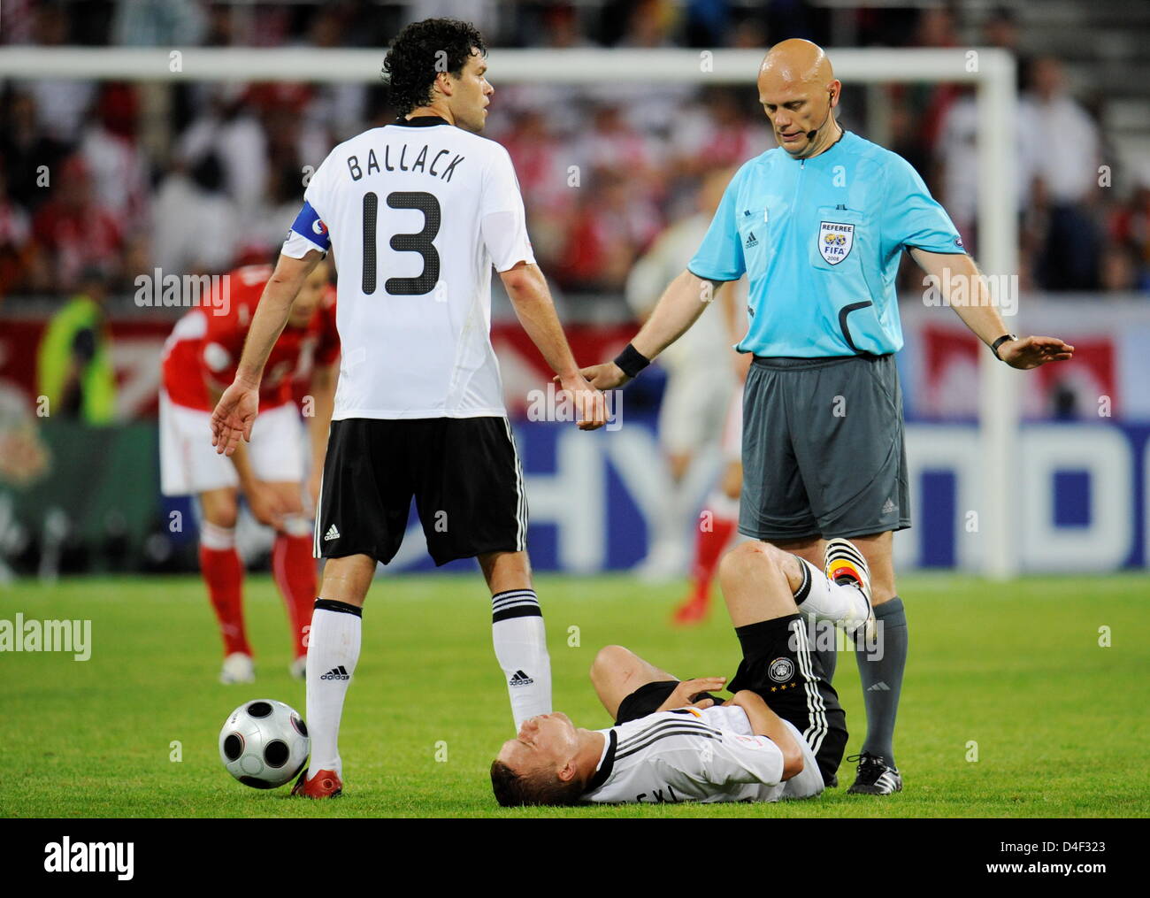 Team captain Michael Ballack (L) argues with referee Tom Henning Ovrebo after Lukas Podolski (bottom) of Germany received a kick between his legs by Dariusz Dudka (not pictured) during the EURO 2008 preliminary round group B match in Woerthersee Stadium, Klagenfurt, Austria, 08 June 2008. Photo: Peter Kneffel dpa +please note UEFA restrictions particularly in regard to slide shows  Stock Photo