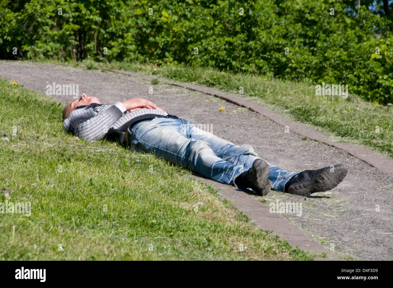 A drunk sleeping in a park, Tallinn Old Town, Tallinn, Estonia, Baltic States Stock Photo