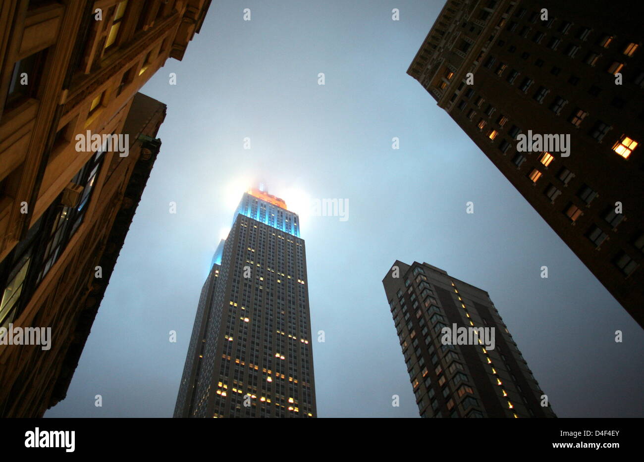 The Empire State Building Is Covered In Clouds In Manhatten New