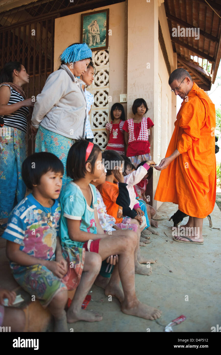 Mae Sai, Thailand, an English monk distributed sweets untern children Stock Photo