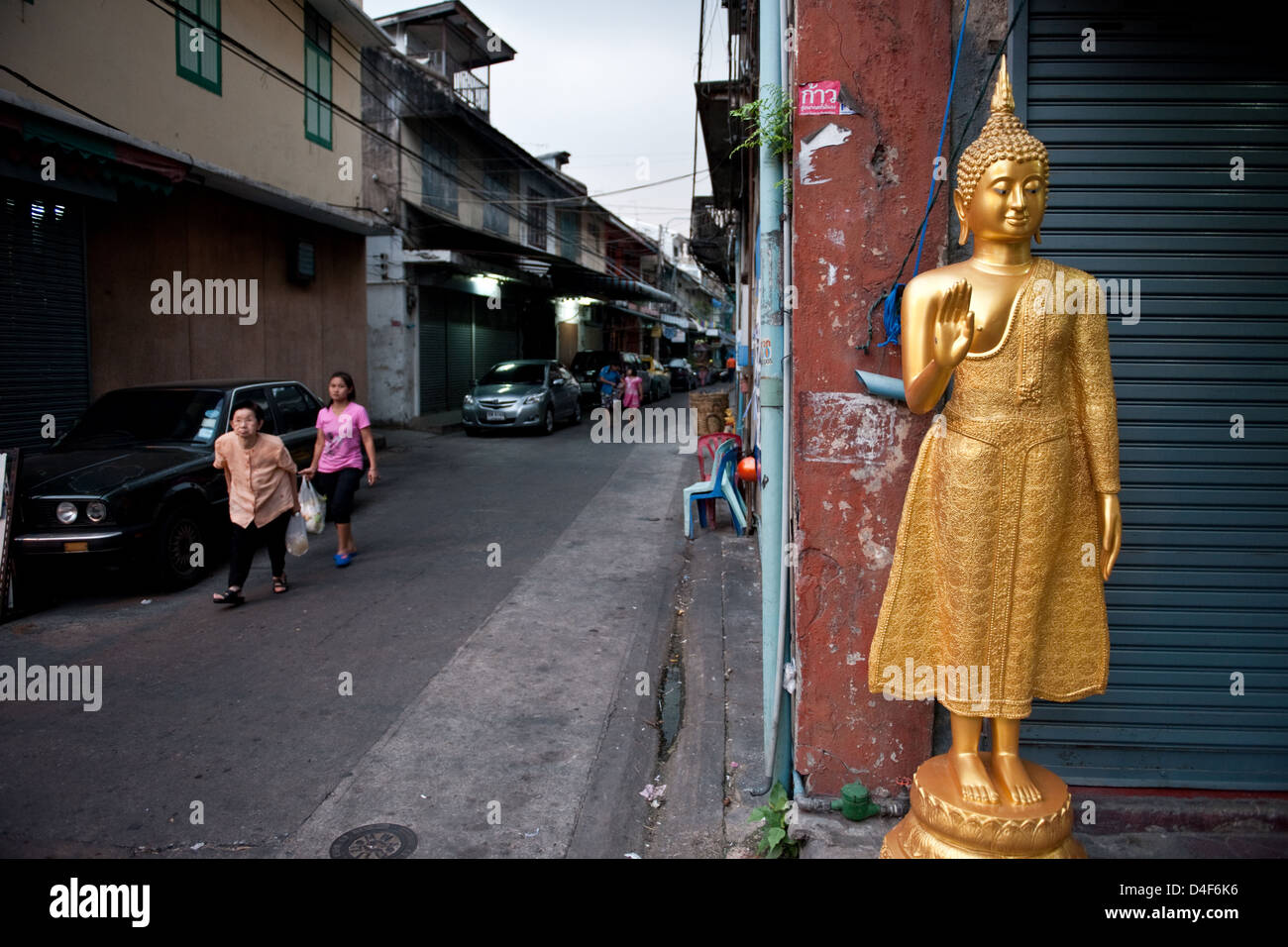 Bangkok, Thailand, Buddha statue in front of a closed shop a street corner Stock Photo Alamy