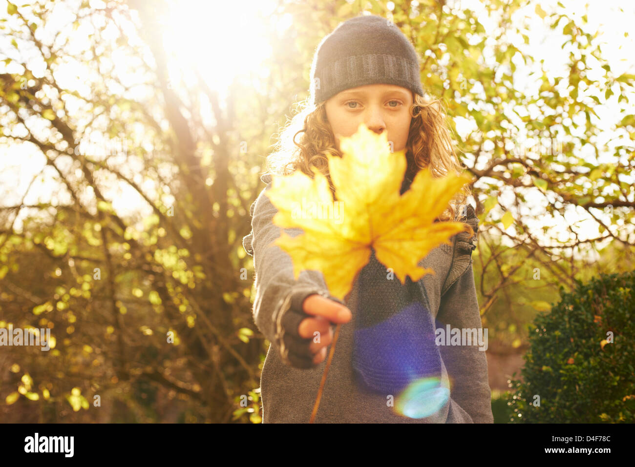 Girl holding autumn leaf outdoors Stock Photo - Alamy