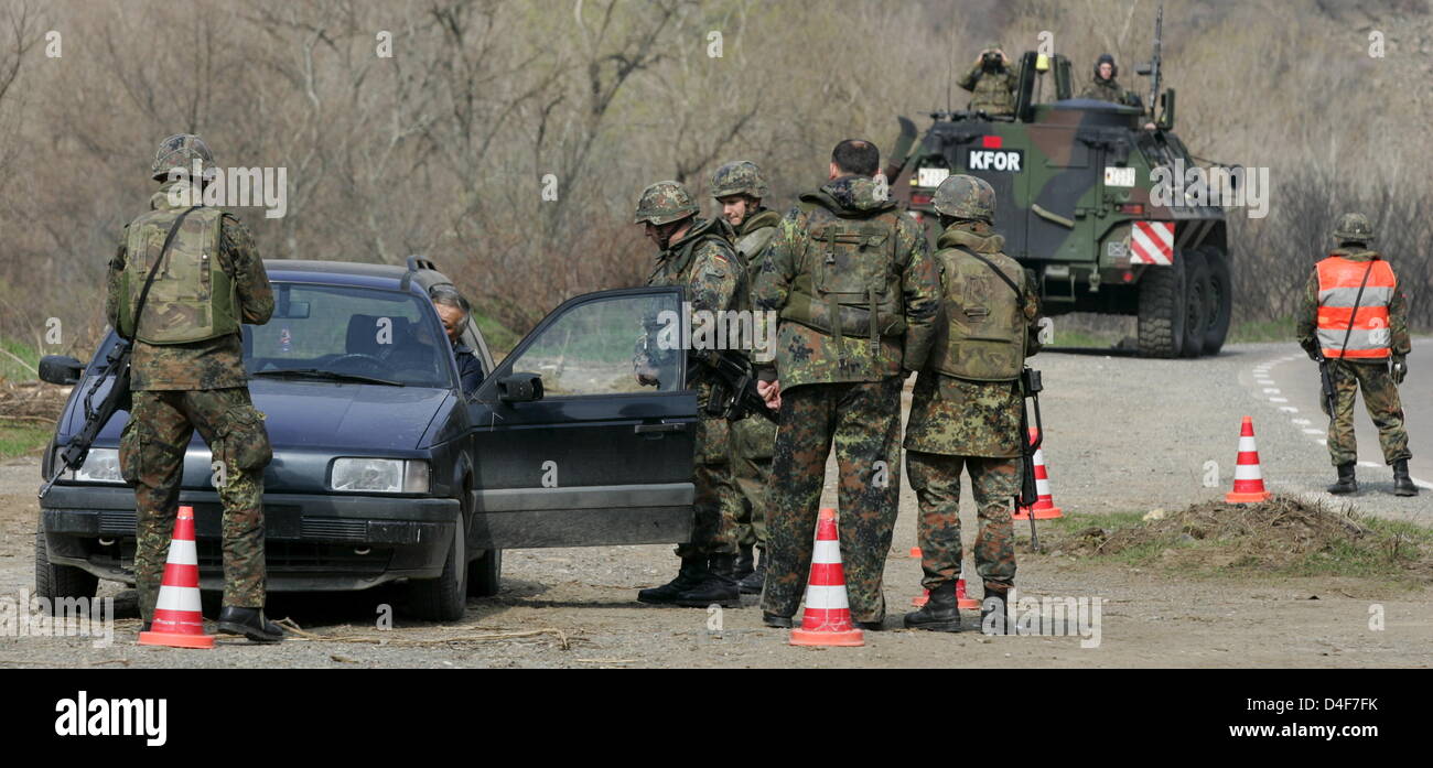 German Bundeswehr soldiers check cars and drivers during a road check ...