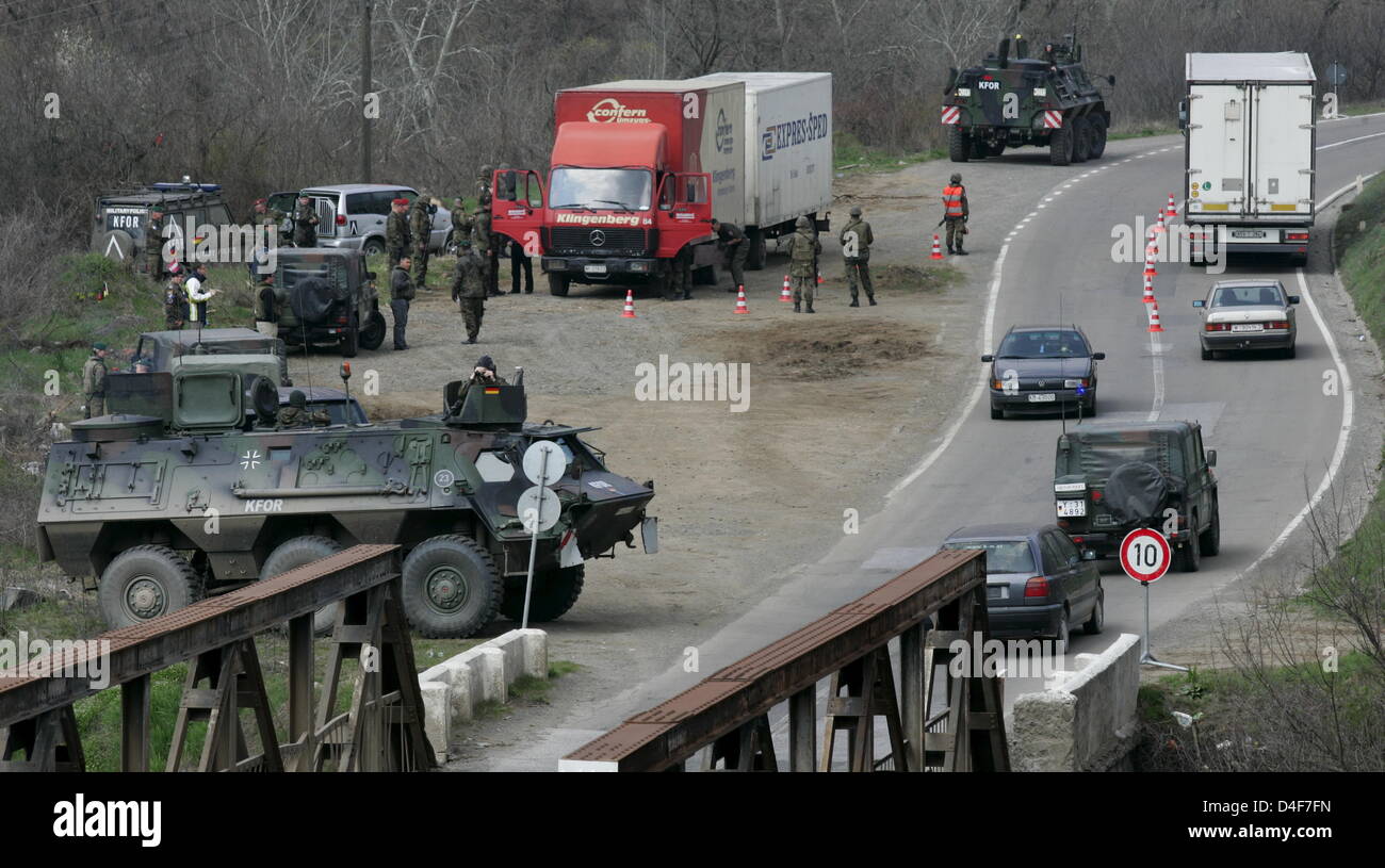 German Bundeswehr soldiers check cars and drivers during a road check ...
