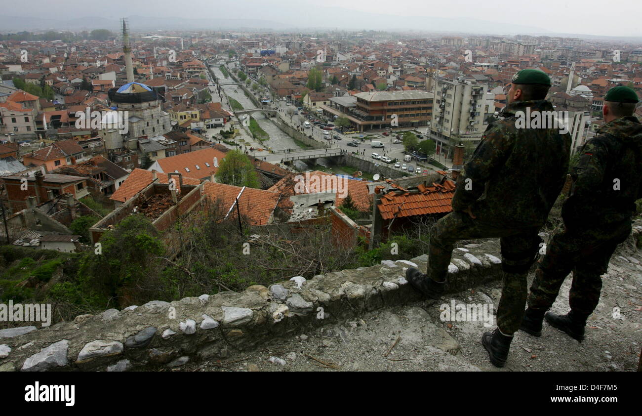 Two soldiers of German Bundeswehr monitor the city of Prizren, Kosovo ...