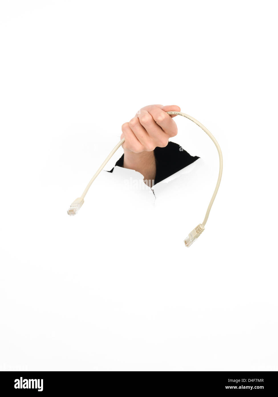 close-up of female hand holding a network cable through a torn white paper, isolated Stock Photo