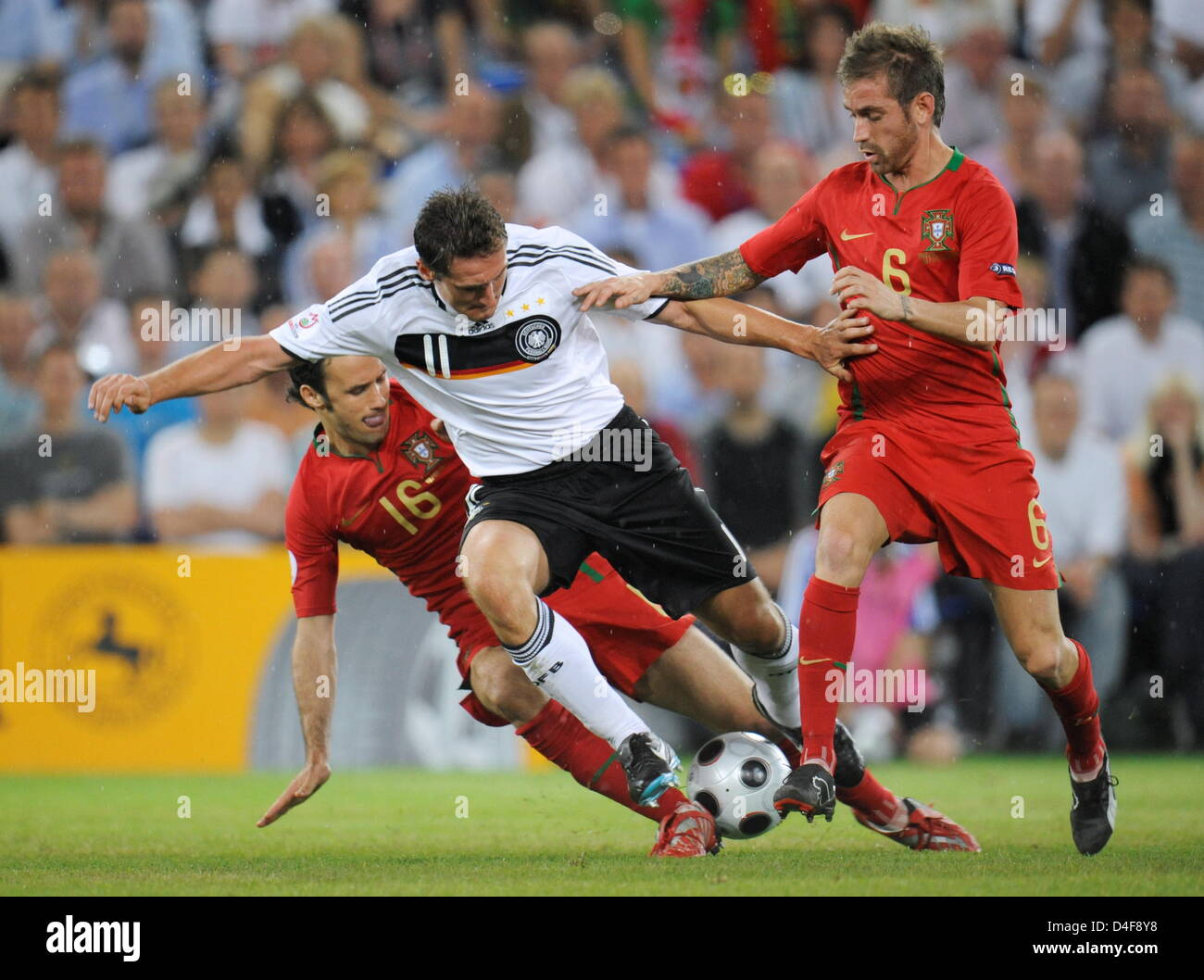 Ricardo Carvalho (L) and Raul Meireles (R) of Portugal fight for the ball with Miroslav Klose (C) of Germany during the UEFA EURO 2008 quarter final match between Portugal and Germany at the St. Jakob-Park stadium in Basel, Switzerland 19 June 2008. Photo: Peter Kneffel dpa +please note UEFA restrictions particulary in regard to slide shows and 'No Mobile Services'+ +++(c) dpa - Bi Stock Photo