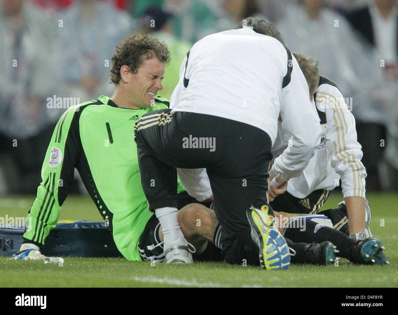 Goalkeeper Jens Lehmann (bottom) of Germany receives medical treatment during the UEFA EURO 2008 quarter final match between Portugal and Germany at the St. Jakob-Park stadium in Basel, Switzerland 19 June 2008. Photo: Ronald Wittek dpa +please note UEFA restrictions particulary in regard to slide shows and 'No Mobile Services'+ +++(c) dpa - Bildfunk+++ Stock Photo