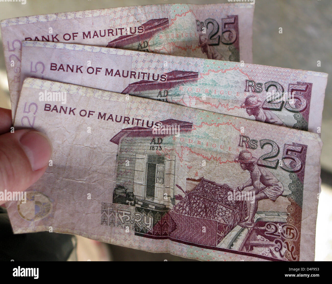 Three bills amounting to 25 rupees are pictured somewhere on Mauritius ...