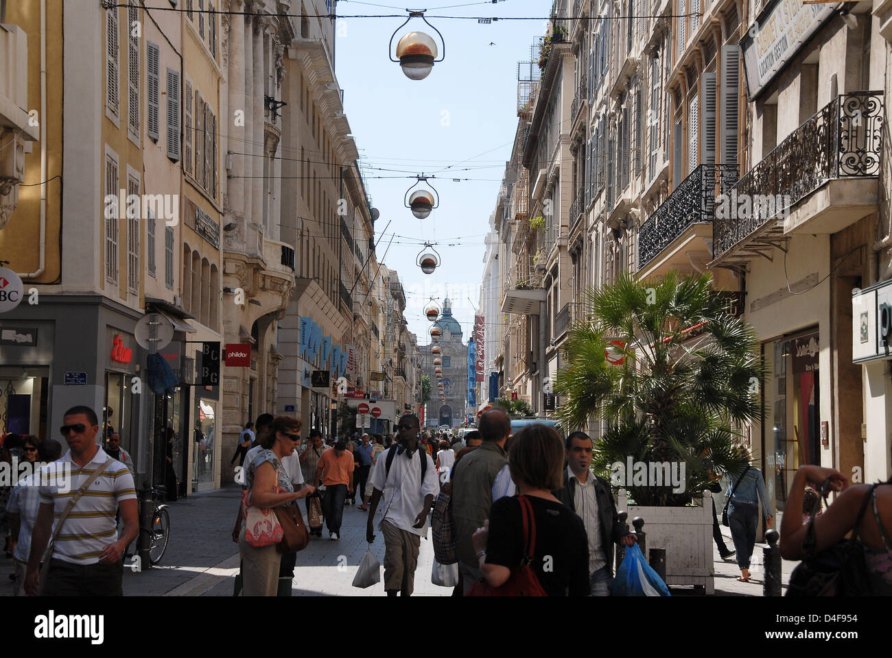 People promenade the Rue St. Ferreol boulevard in downtown Marseille ...