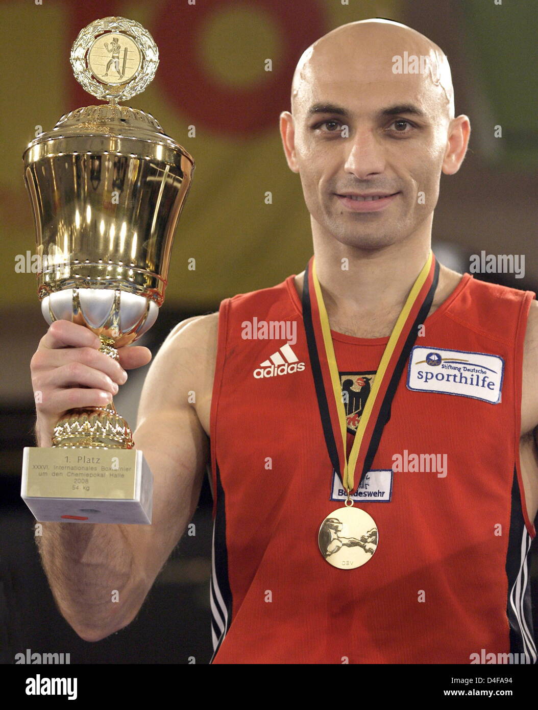 German Rustam Rahimov presents his trophy after winning the
