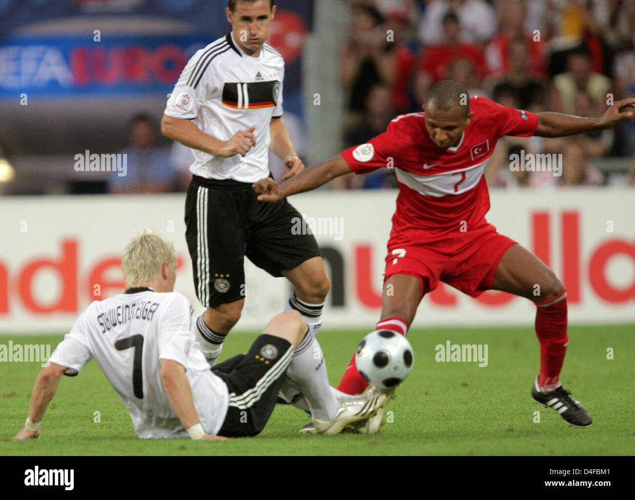 Bastian Schweinsteiger (L) and Miroslav Klos (C) of Germany vie with Mehmet Aurelio of Turkey during the UEFA EURO 2008 semifinal match between Germany and Turkey at the St. Jakob-Park stadium in Basel, Switzerland, 25 June 2008. Photo: Ronald Wittek dpa +please note UEFA restrictions particulary in regard to slide shows and 'No Mobile Services'+ +++(c) dpa - Bildfunk+++ Stock Photo