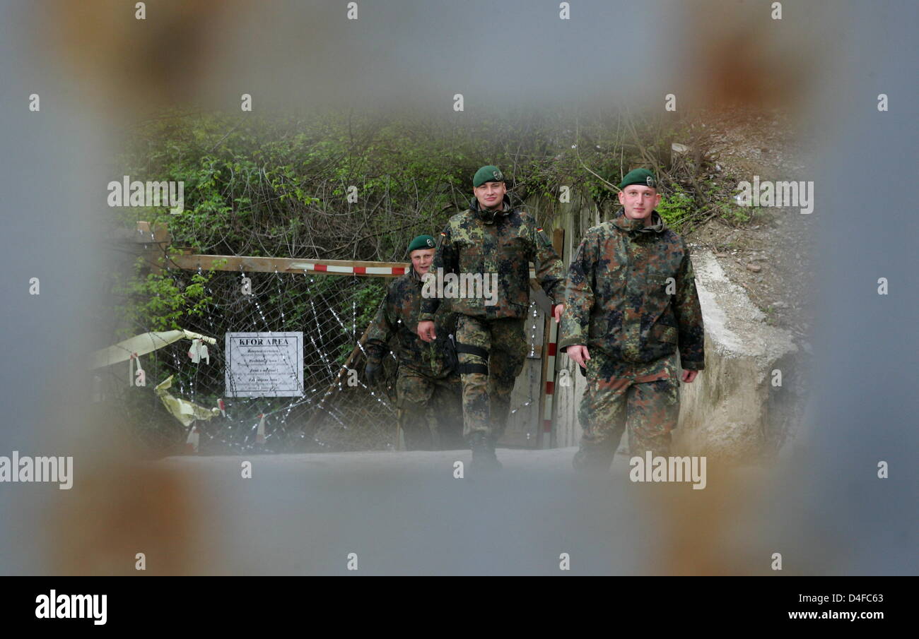 Two soldiers of German Bundeswehr patrol the destroyed and still closed ...
