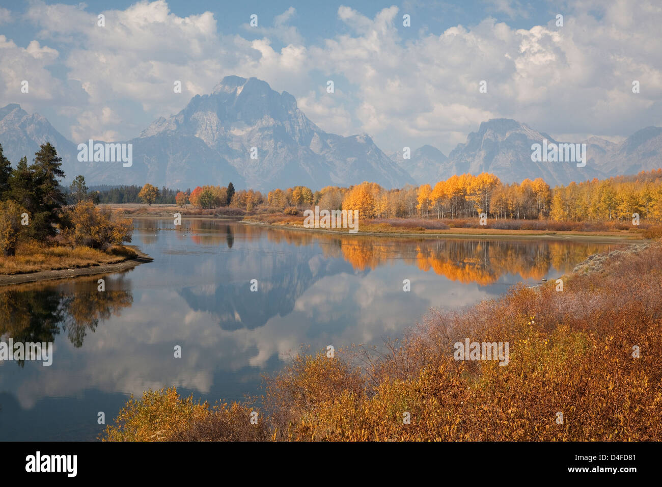 Mountains and sky reflected in still river Stock Photo - Alamy