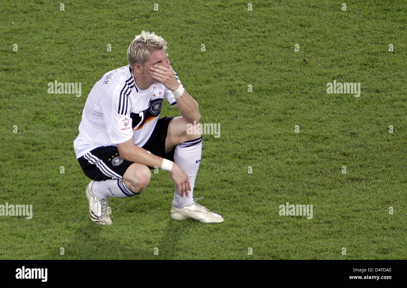 Dejected German player Bastian Schweinsteiger dejectedly crouches on the pitch after Spain defeated Germany 1-0 during the UEFA EURO 2008 final match between Germany and Spain at the Ernst Happel stadium in Vienna, Austria, 29 June 2008. Photo: Oliver Berg dpa +please note UEFA restrictions particulary in regard to slide shows and 'No Mobile Services'+ +++###dpa###+++ Stock Photo