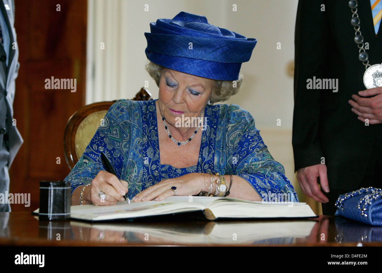 Beatrix Emahauser Queen Beatrix of the Netherlands signs the golden book at the Elector ...