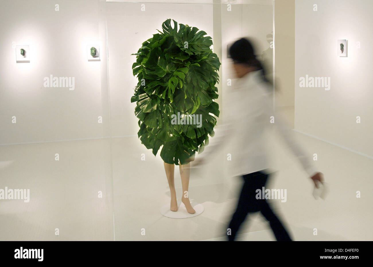 A woman passes the artwork 'Leaves Mannequin' by Japanese artist Makoto Azuma at the exhibition 'Makoto Azuma: Botanical Sculpture' at the NRW Forum in Duesseldorf, Germany, 04 July 2008. The exhibition runs from 05 July through 03 August 2008. Photo: FRANZ-PETER TSCHAUNER Stock Photo
