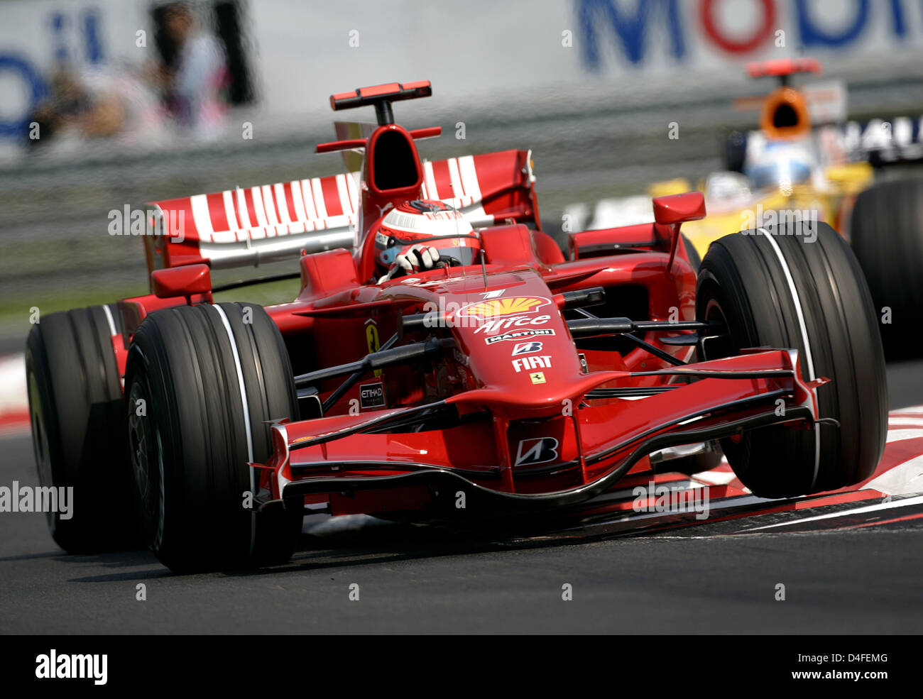 Finnish Formula One driver Kimi Raikkonen of Ferrari (L) steers his car