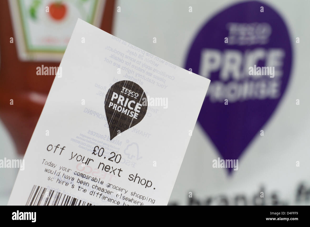 Tesco price promise comparable money off shopping coupon Stock Photo
