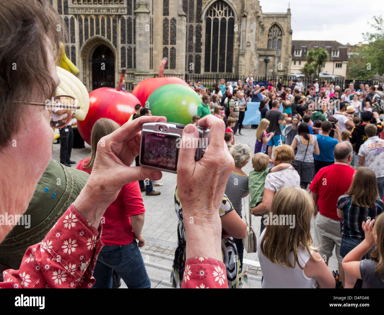 Crowds of people gathered round Titan the Robot performing at the Forum