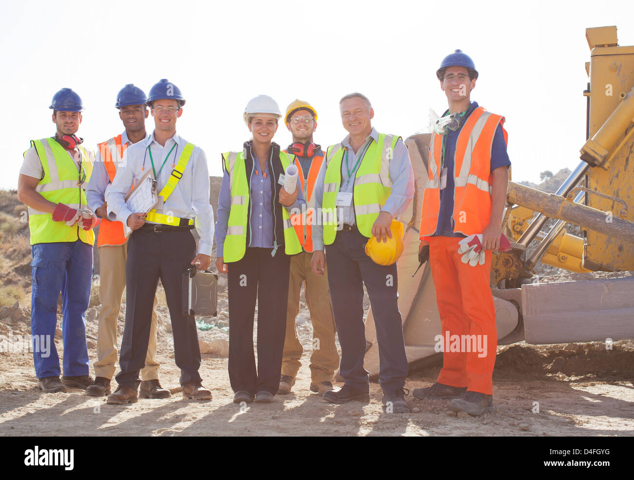 Workers and business people smiling at quarry Stock Photo