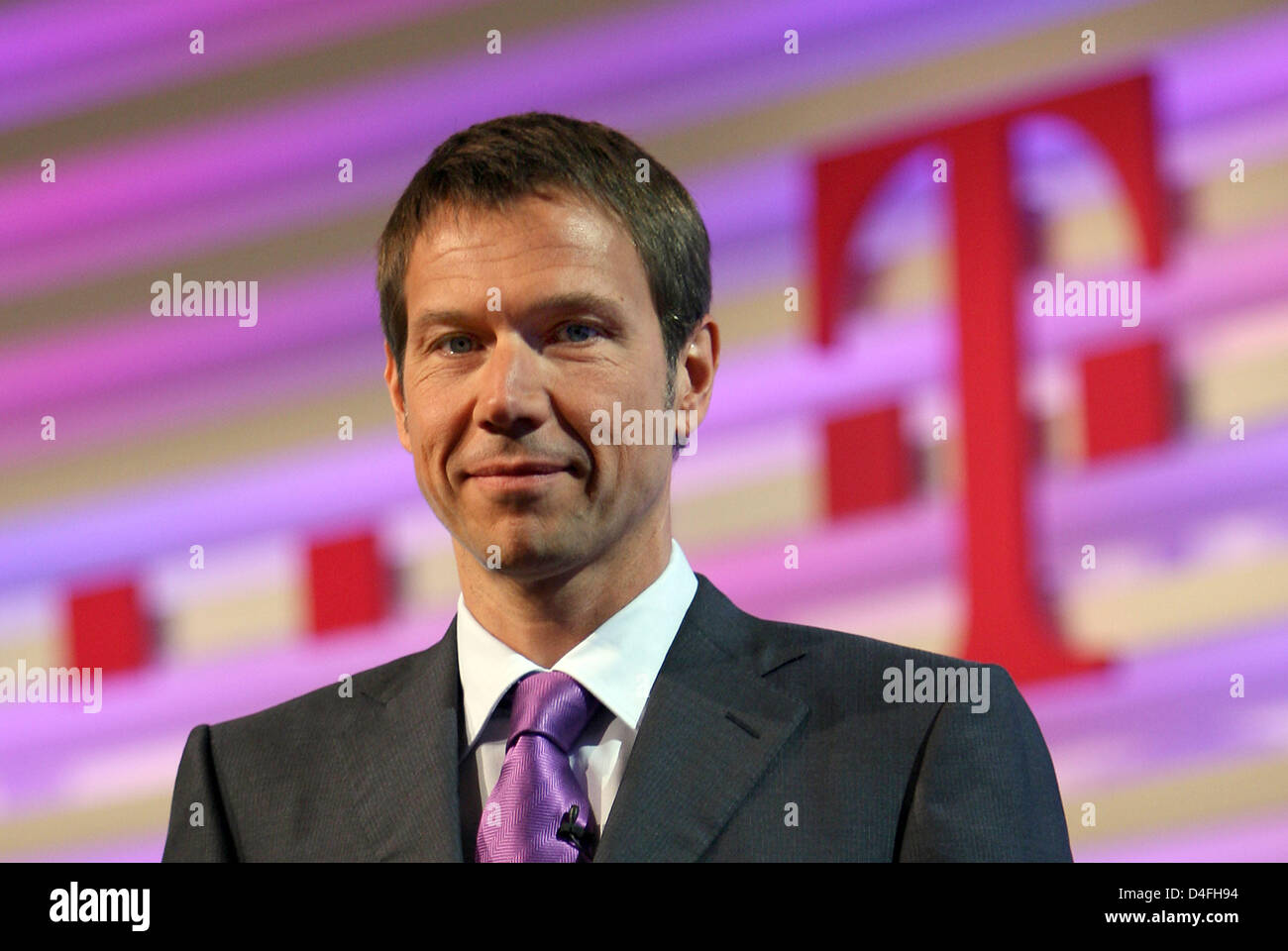 Rene Obermann, CEO of 'Deutsche Telekom' seen in front of the company logo ahead of the announcement of the company's financial figures in Bonn, Germany, 7 August 2008. In the second quarter of 2008 Telekom recorded a drop in revenues due to the strong Euro. Photo: OLIVER BERG Stock Photo