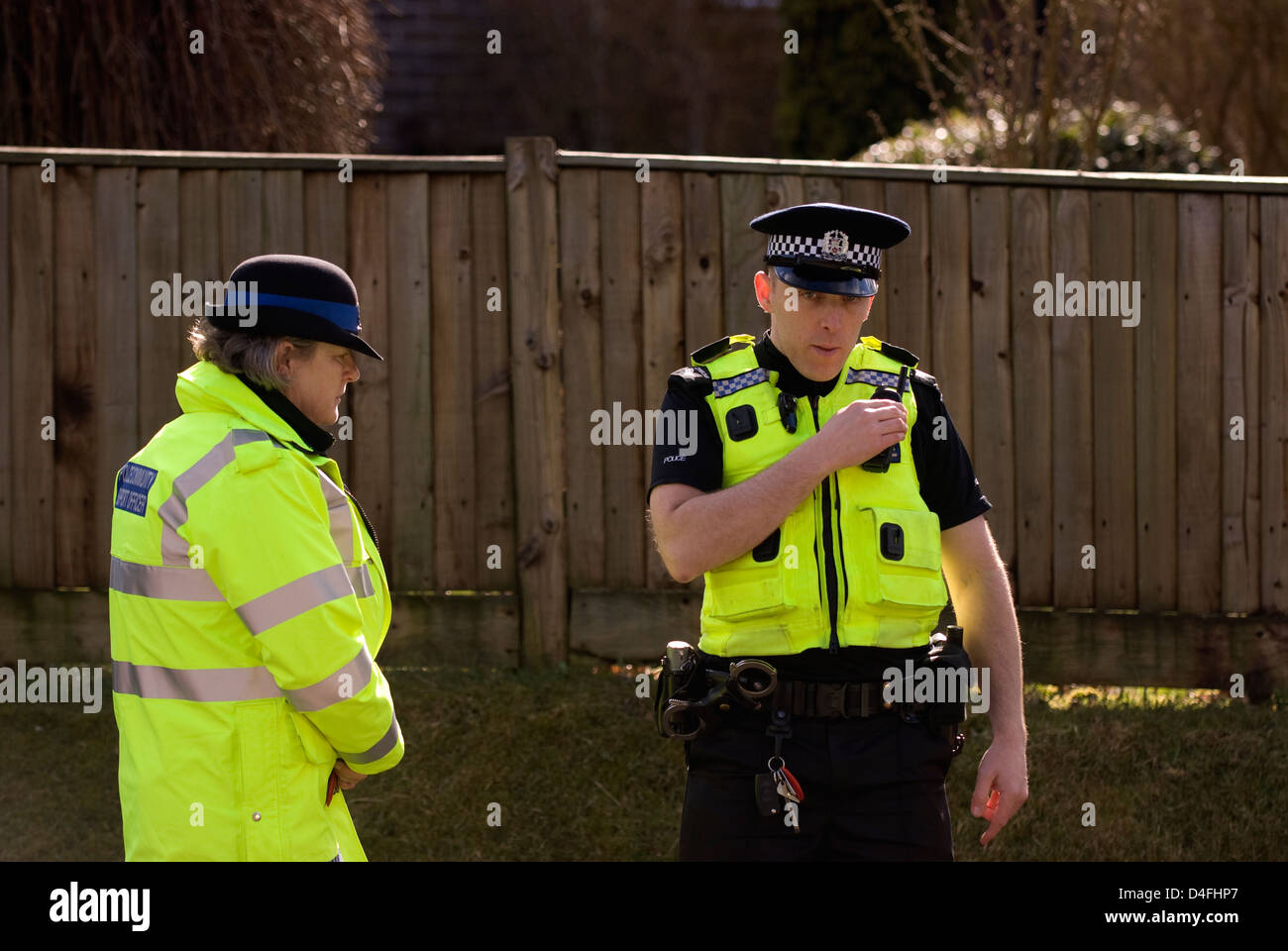 Police officer and PCSO near scene of suspect arrested for threats to kill, Selborne, Hampshire, UK. Stock Photo