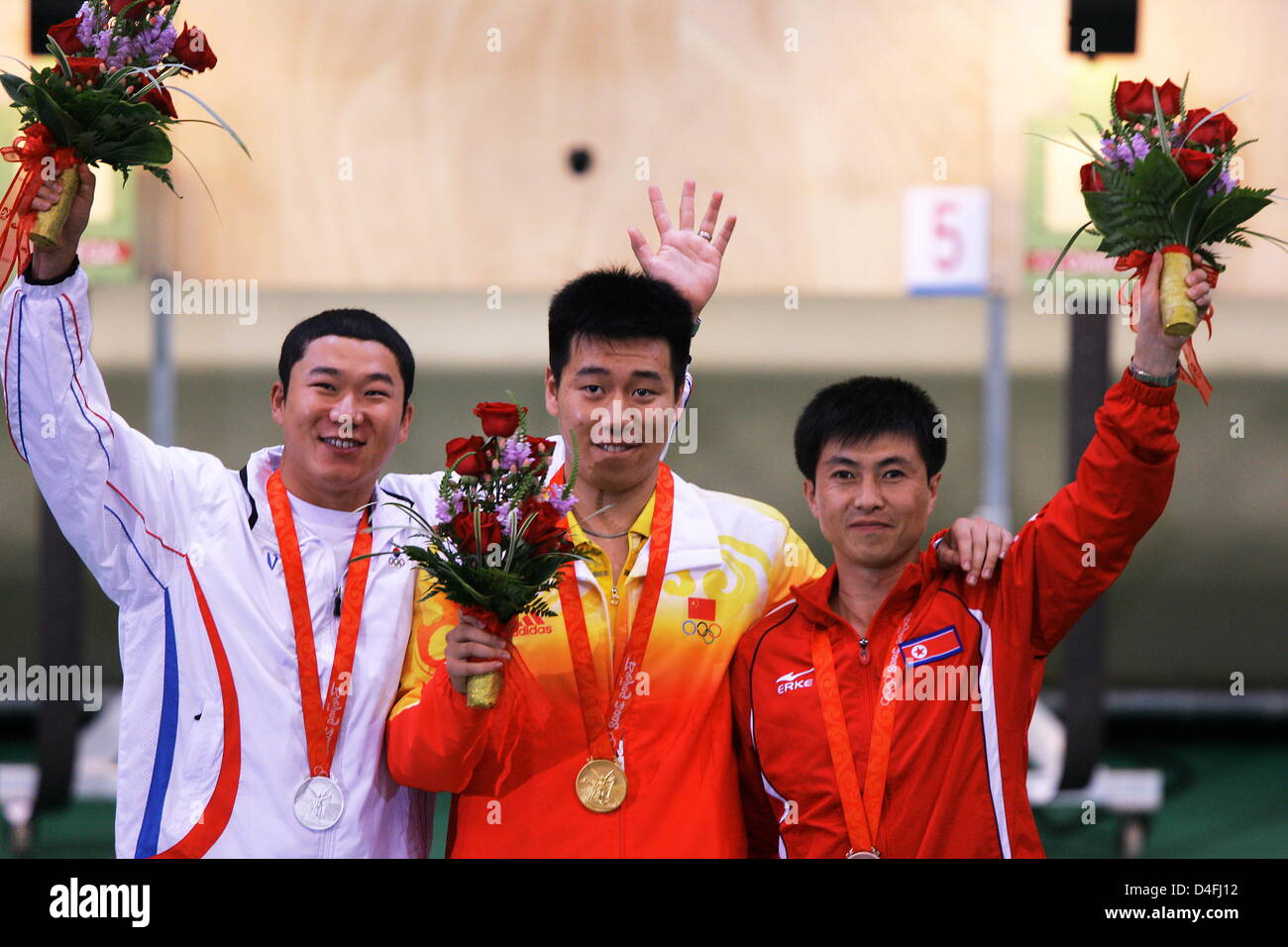 Gold medal winner Chinese Wei Pang (C) is flanked by silver medallist South Korean Jong Oh Jin (L) and bronze medallist North Korean Jong Su Kim (R) during the medal ceremony in the men`s 10m air pistol final in the Beijing Shooting Range Hall at the Beijing 2008 Olympic Games, China, 09 August 2008. Photo: Jens Buettner (c) dpa - Bildfunk Stock Photo