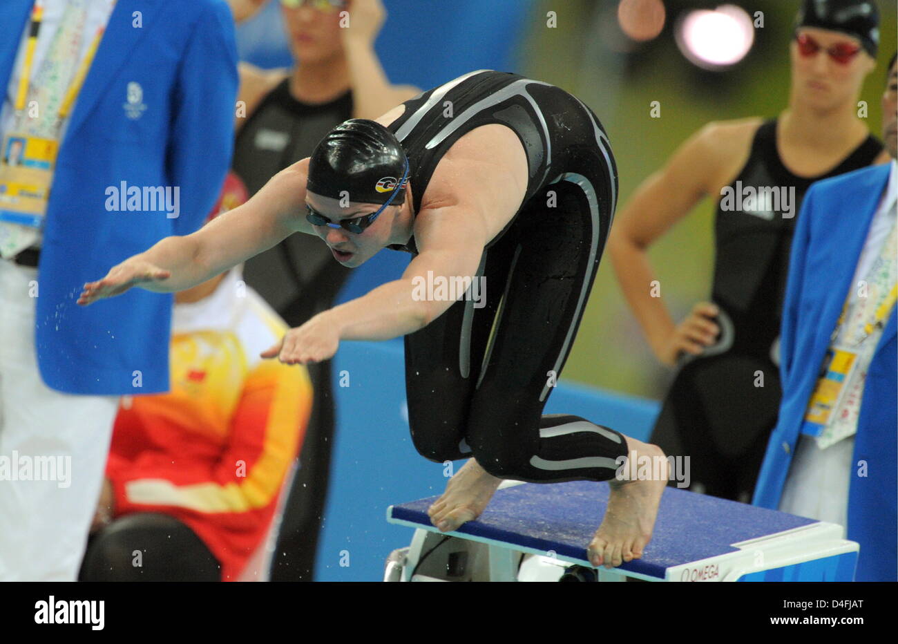 German swimmer Britta Steffen enters the pool while teammate Antje Busschulte (R) looks on during the finals of the 4 x 100 M women's freestyle relay during the Beijing 2008 Olympic Games in Beijing, China 10 August 2008. Photo: Bernd Thissen dpa (c) dpa - Bildfunk Stock Photo