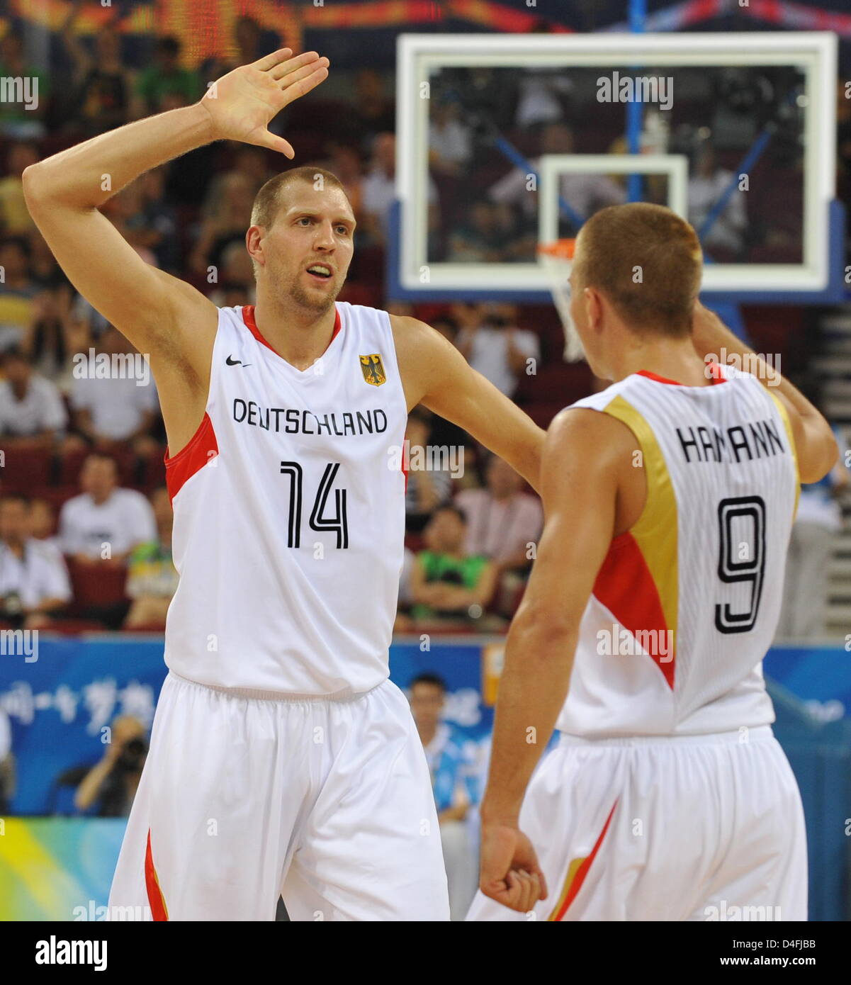 dpa) - German basketball star Dirk Nowitzki warms up ahead of the  basketball match Germany vs USA in Cologne, Germany, 4 August 2004. The  Olympic 'Dream Team' from the United States closely