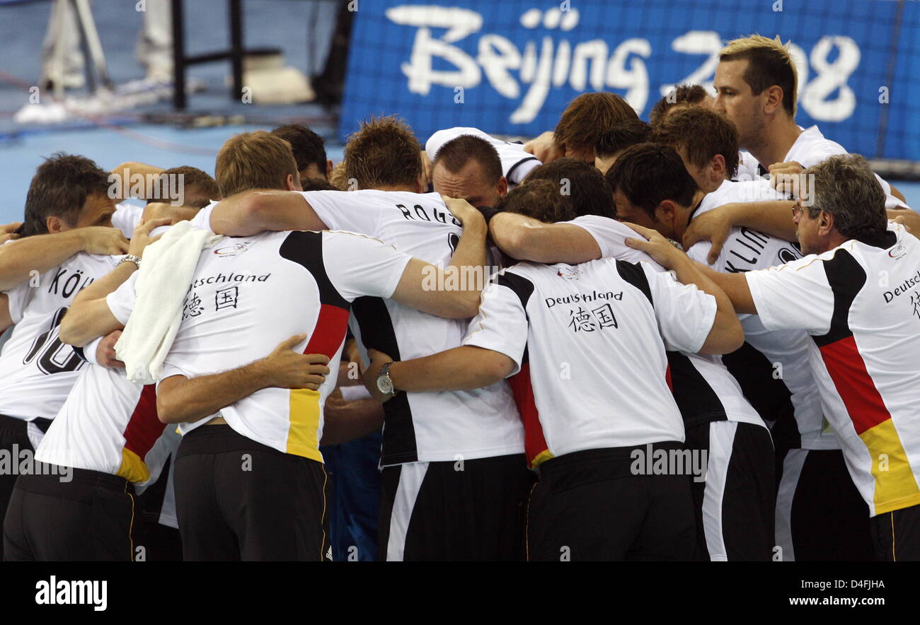 Players of Germany celebrate the victory after the menÒs handball preliminary round group B