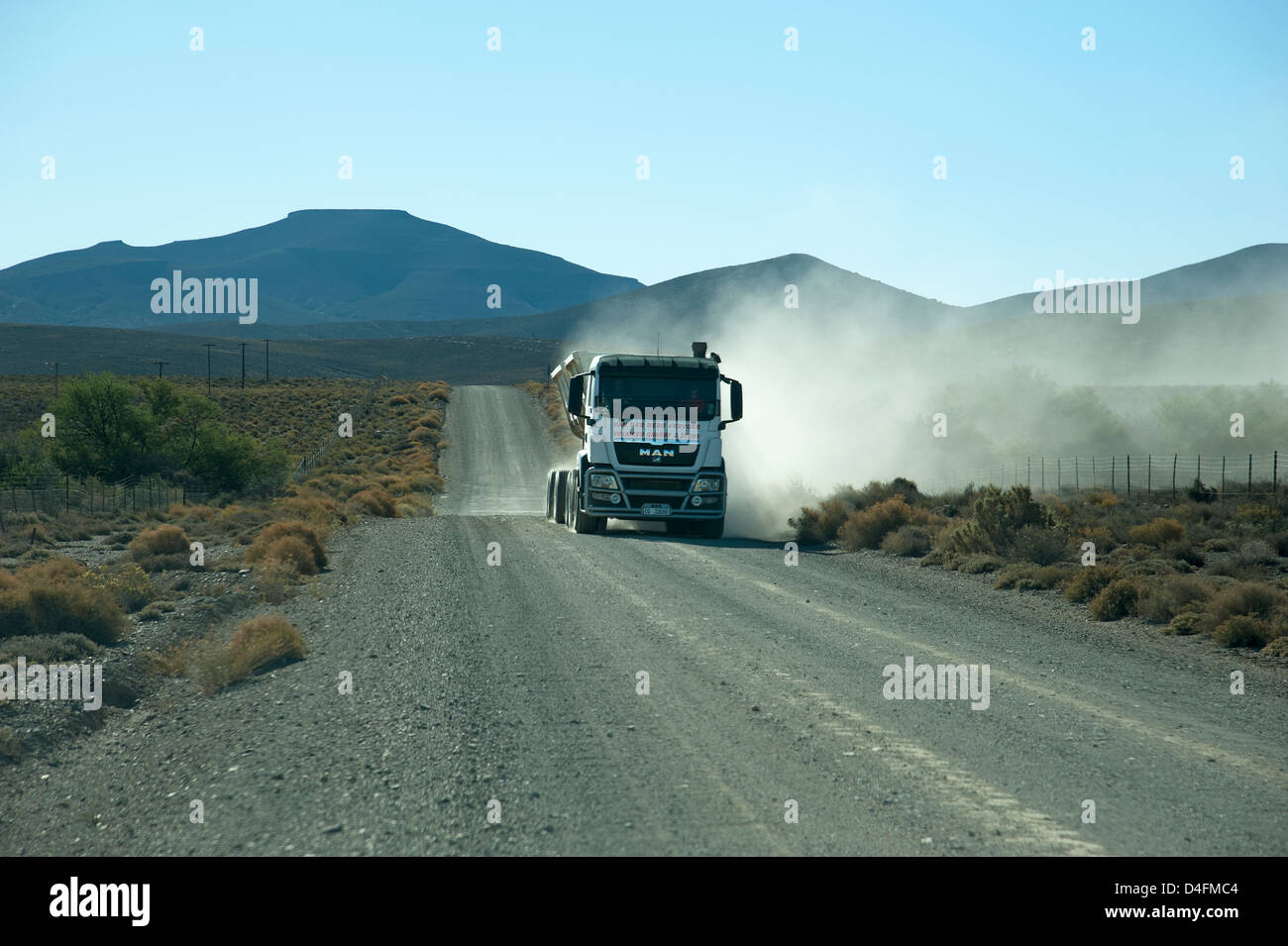 Tipper truck carrying quarried stone on a gravel road in the Karoo region South Africa Stock Photo
