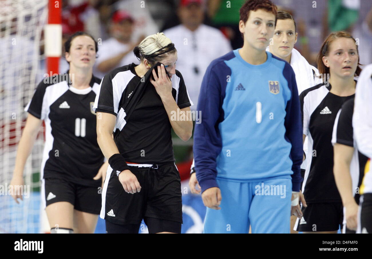 Players of Germany leave the pitch dejected after the womenÒs handball ...