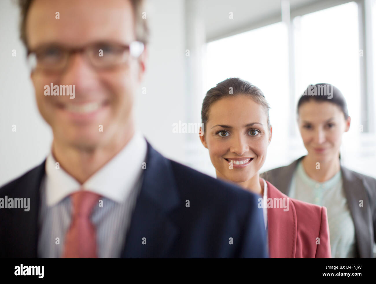 Business people smiling in office Stock Photo - Alamy
