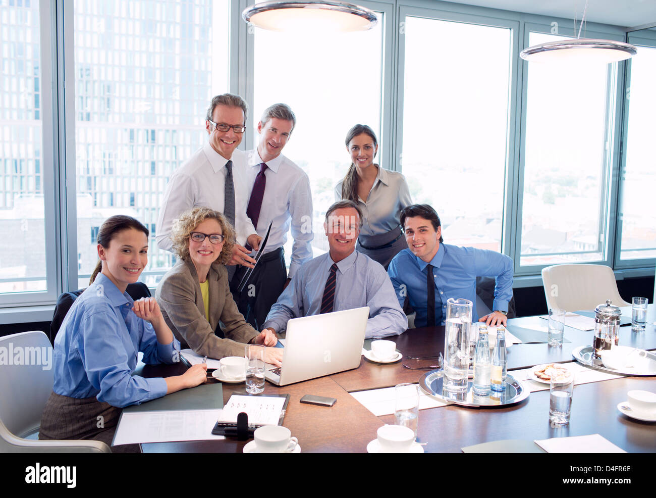 Business people smiling in meeting Stock Photo