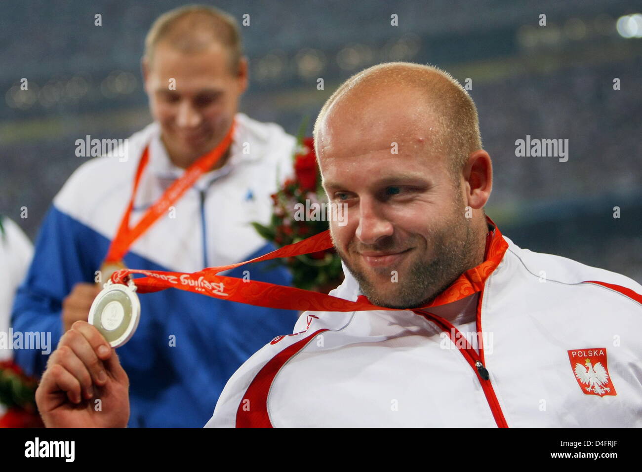 Silver Medalist Piotr Malachowski Of Poland R And Gold Medalist Gerd Kanter Of Estonia Leave The Podium After The Medal Ceremony For Men S Discus Throw In The National Stadium During The Beijing