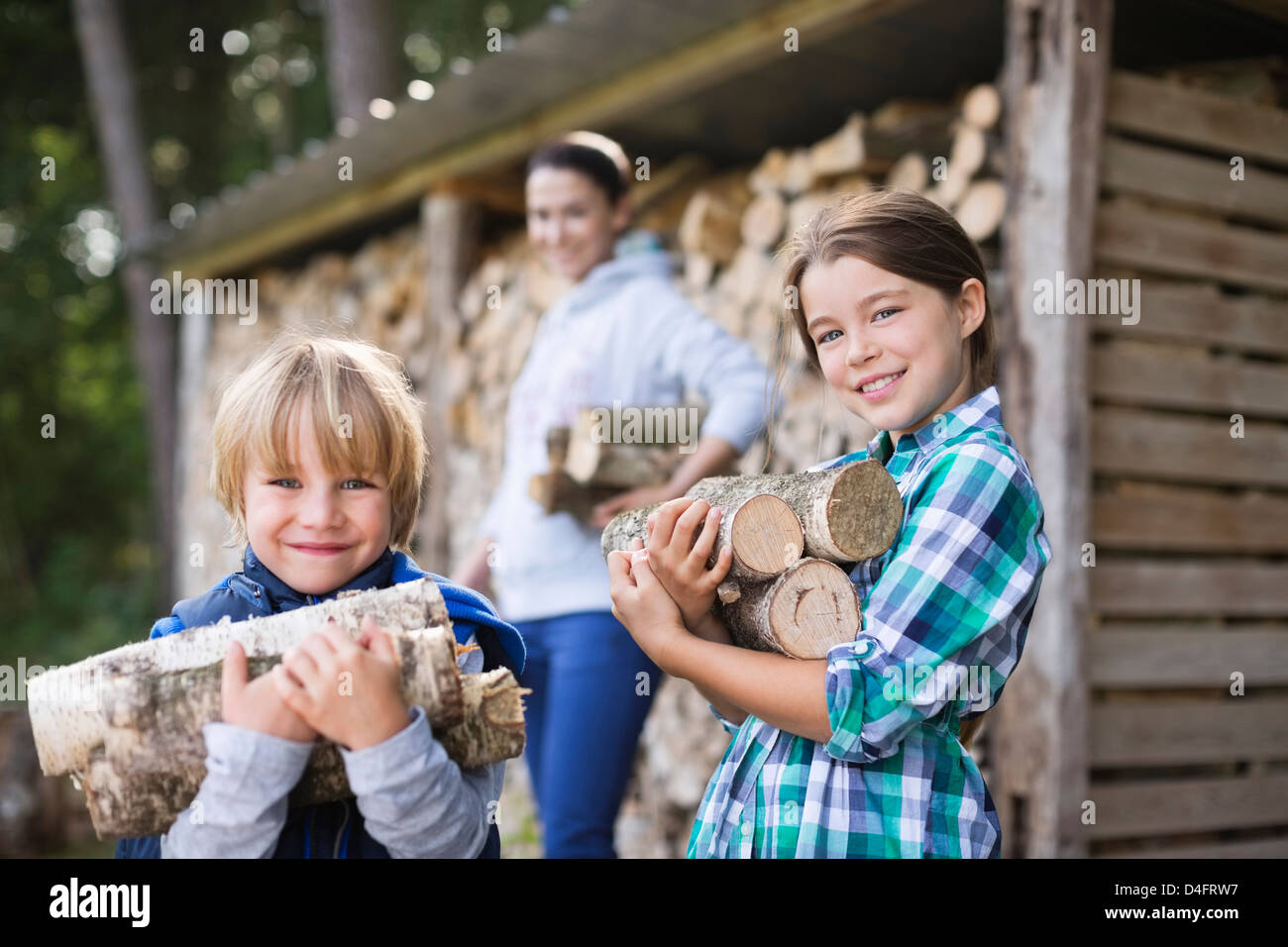 Children carrying firewood outdoors Stock Photo - Alamy